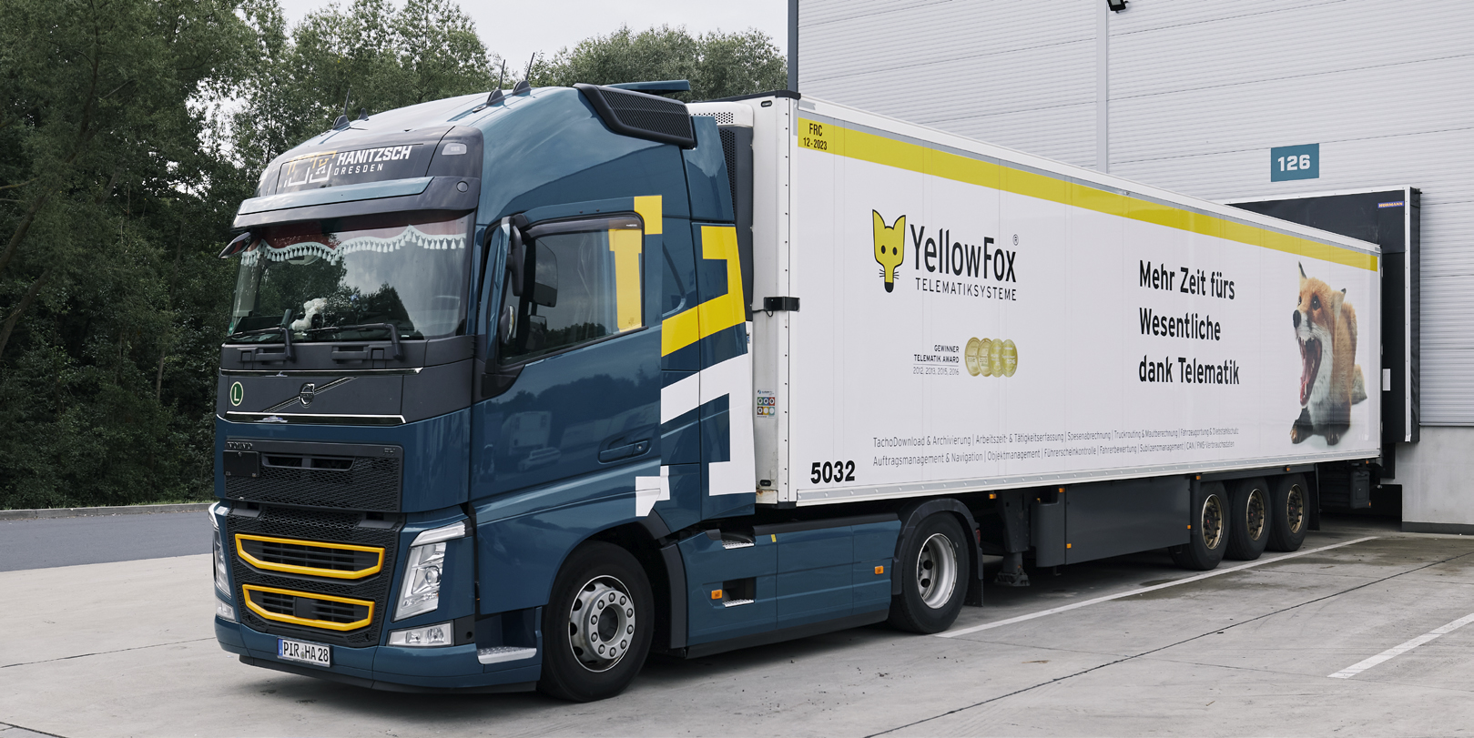 A YellowFox Telematics Systems company truck situated in a vacant parking lot.
